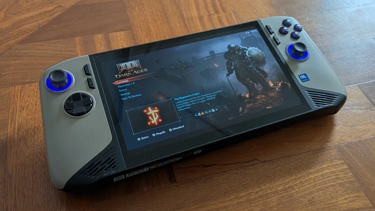 The MSI Claw 8 AI+ A2VM gaming handheld on a wooden table running Doom: The Dark Ages