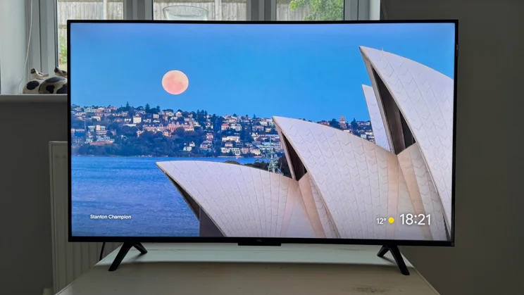 Front view of the TCL P7K QLED TV displaying an image of the Sydney Opera House at sunset