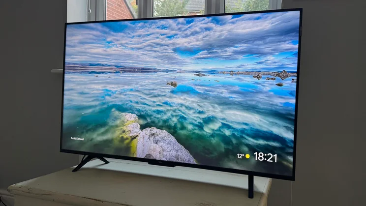 Angled view of the TCL P7K QLED TV from the right-hand side displaying an image of an ocean scene