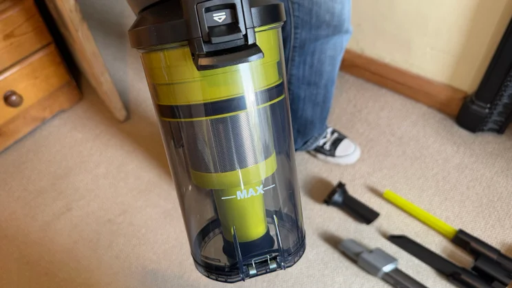 A close up of the Ryobi 18V ONE+ Cordless Stick's dust collection bin