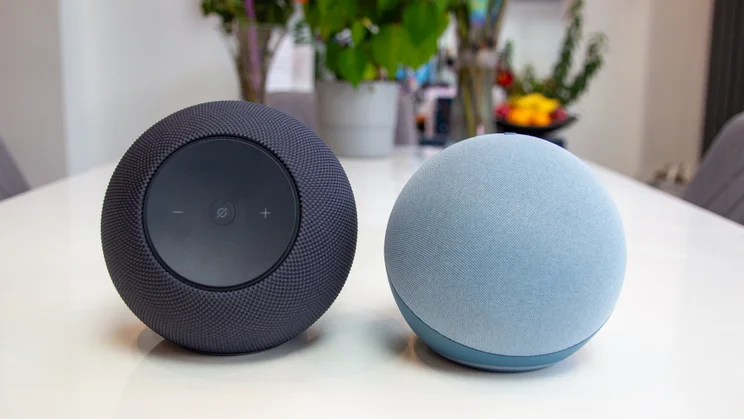 The Amazon Echo Studio 2025 pictured alongside the old Echo Dot