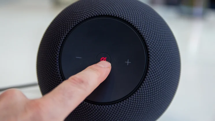 The Amazon Echo Studio 2025 with someone pressing the mute button in the centre. White background