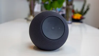 The Amazon Echo Studio 2025 pictured on a white table with plants in the background