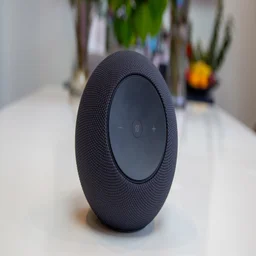 The Amazon Echo Studio 2025 pictured on a white table with plants in the background