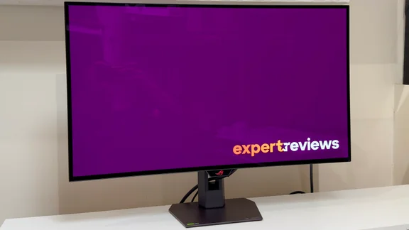 The Asus ROG Strix XG32UCWG pictured on a white desktop from a slight angle and to the left