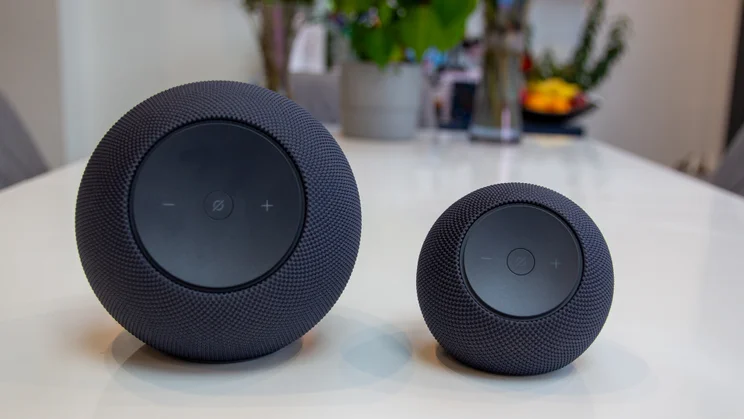 Amazon Echo Dot Max on a white table, photographed next to the 2025 Echo Studio