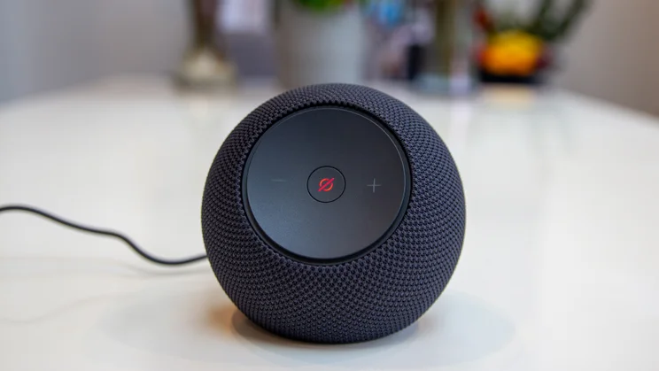 Amazon Echo Dot Max on a white table, photographed with the mute button lit up in red