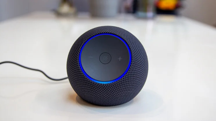 Amazon Echo Dot Max on a white table, photographed with the LED status ring illuminated