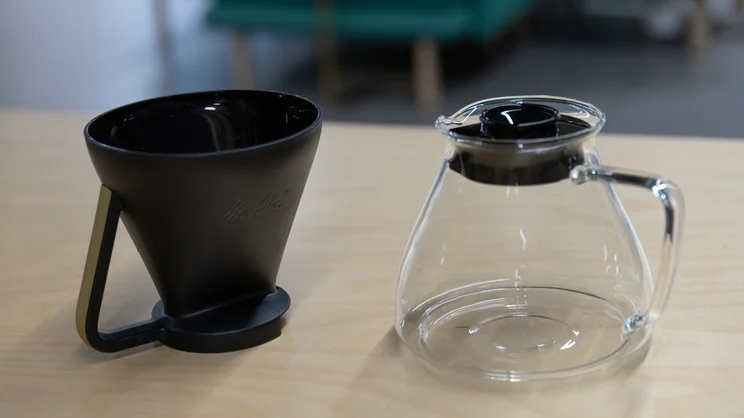 The Melitta EPOS filter coffee machine's filter cone and glass jug on a tabletop