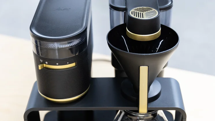 The upper section of the Melitta EPOS filter coffee machine. The filter cone is slotted in place under the brew head