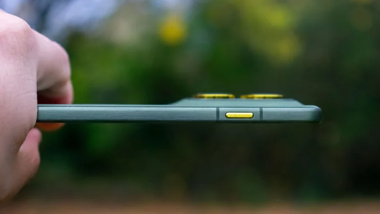 Motorola Edge 70 in hand, showing the side and AI button