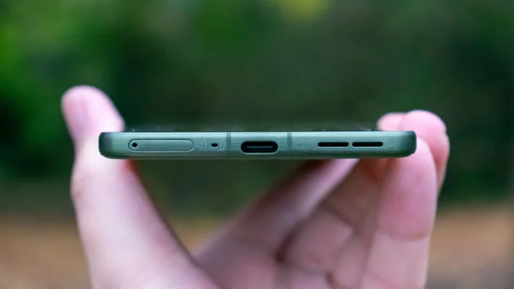 Motorola Edge 70 in hand, showing the bottom edge and charging port