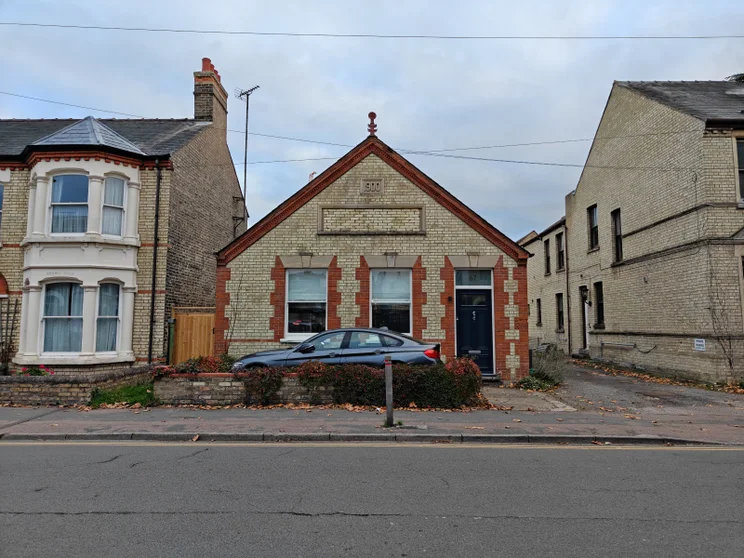 Small building with a road in front of it