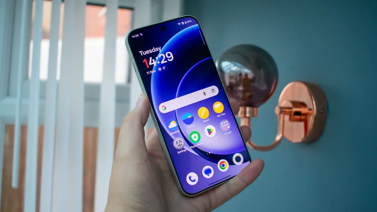 OnePlus 15 in hand, front view with the display on