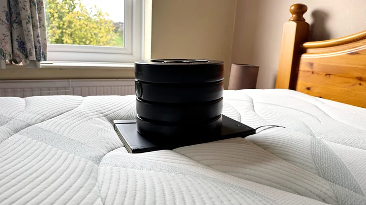 Testing sinkage of the Slumberland Air 6.0 Memory mattress, using a notebook and a series of weights