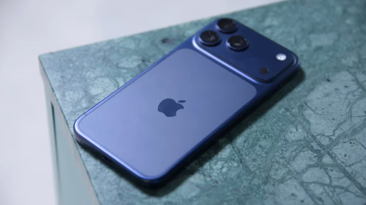 The Apple iPhone 17 Pro Max on a marbled table with the screen facing down