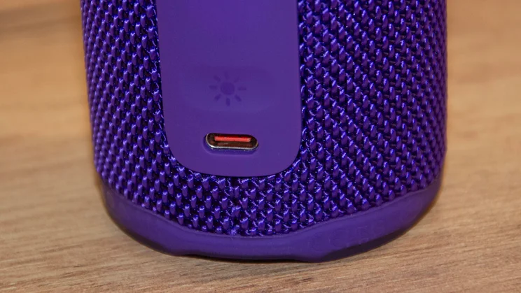 The USB-C port and ambient light button on the rear of the JBL Grip portable Bluetooth speaker
