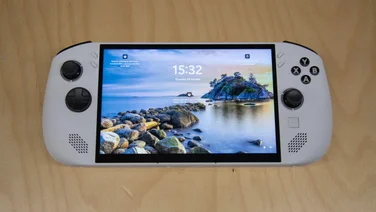 The Lenovo Legion Go S on a wooden table with the Windows lock screen displayed