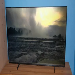 Front view of the Samsung U8000F 4K TV displaying a lake and forest scene