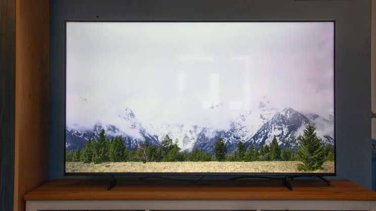 Front view of the Samsung U8000F 4K TV displaying a mountain scene with reflections clearly visible on the panel
