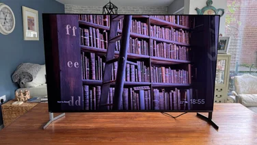 Front view of the Sony Bravia 8 II QD-OLED TV displaying multiple shelves of books in a library