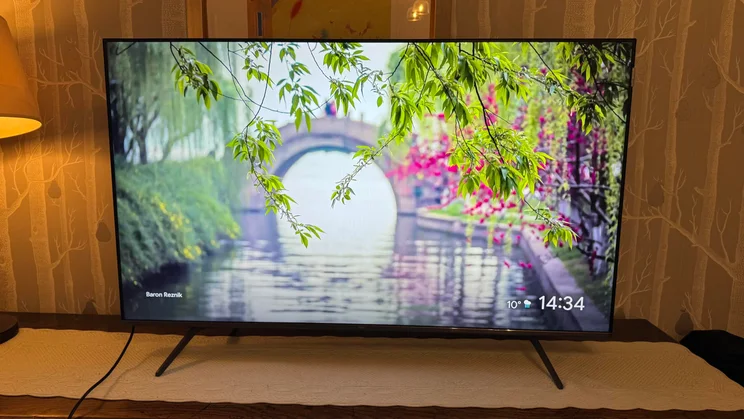 Front view of the TCL C6KS Mini LED TV showing a river scene with a bridge in the background