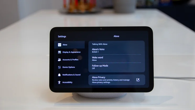 The Amazon Echo Show 8 (4th gen, 2025) pictured from the front on a white table, showing the settings screen