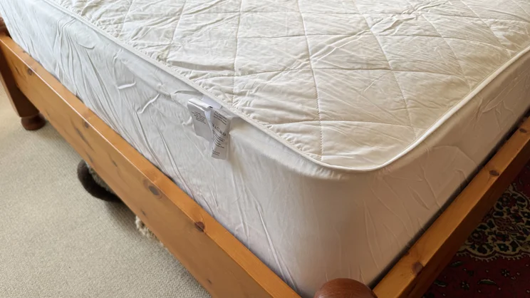 A closeup of a corner of the Dusk Luxury Quilted Mattress Protector, on a mattress