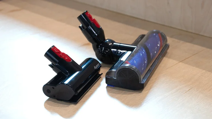 The Dyson V8 Cyclone's motorbar cleanerhead and mini motorised tool on a bench in an office