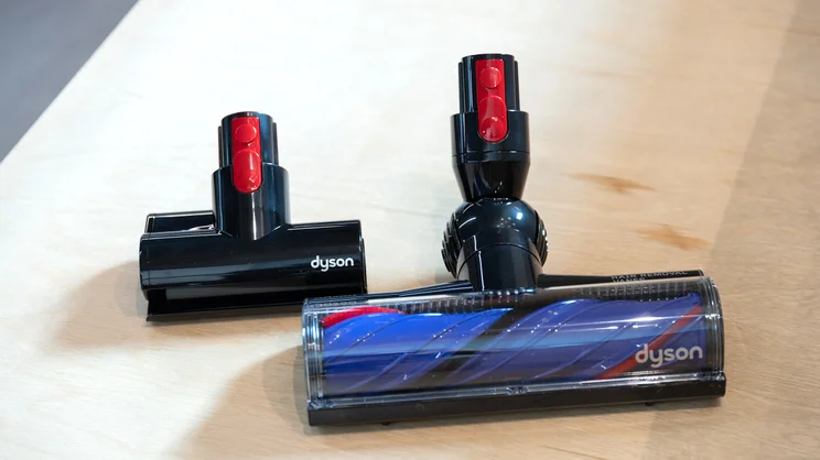 The Dyson V8 Cyclone's motorbar cleanerhead and mini motorised tool on a bench in an office