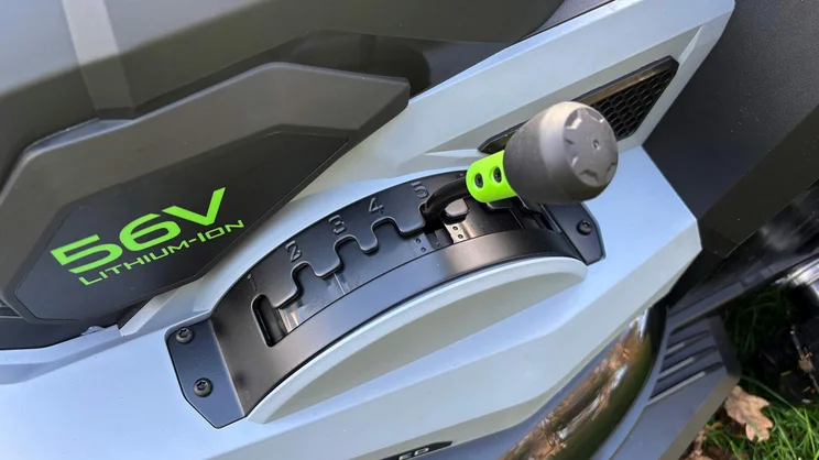 A closeup of the LM2236E-SP lawn mower's height adjustment lever