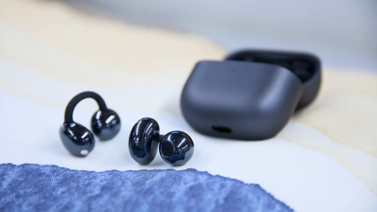 Huawei FreeClip 2 out of case on white and blue fabric