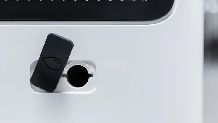 The Meaco DD8L Pro dehumidifier's continuous drainage output, with cover open