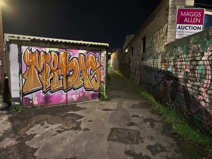 Graffitied alleyway at night