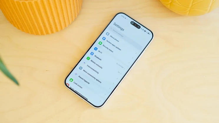 Poco F8 Pro face up on a table, settings on the display