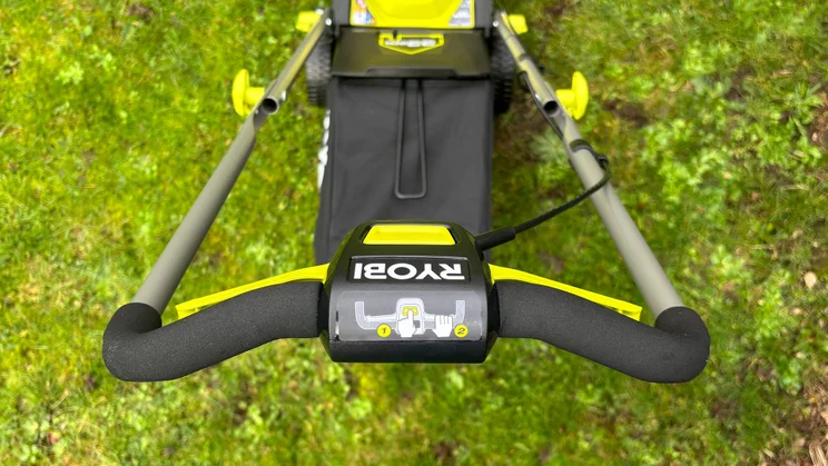 The Ryobi RY18LMX33A lawn mower's controls, viewed from above