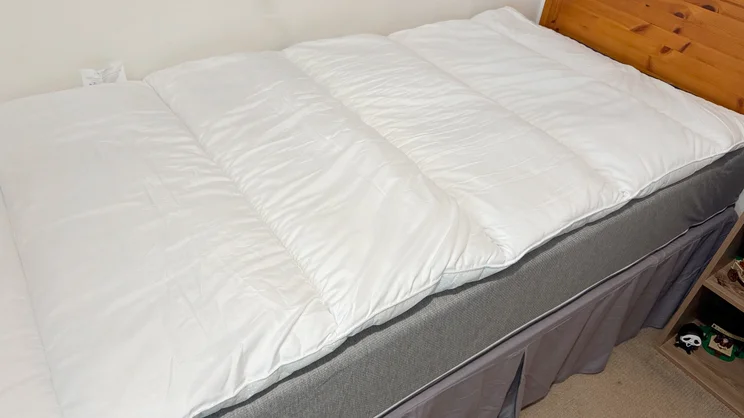 The Slumberdown Sleep Soundly Climate Control mattress topper on a mattress