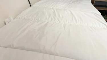 The Slumberdown Sleep Soundly Climate Control mattress topper on a mattress