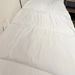 The Slumberdown Sleep Soundly Climate Control mattress topper on a mattress