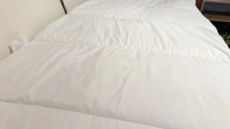 The Slumberdown Sleep Soundly Climate Control mattress topper on a mattress