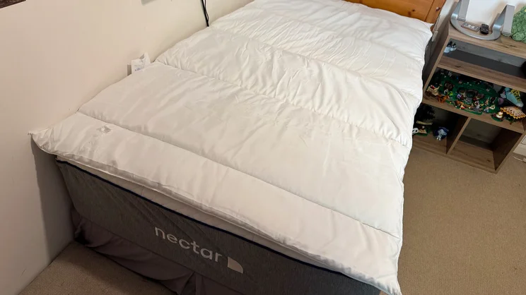 The Slumberdown Sleep Soundly Climate Control mattress topper on a mattress