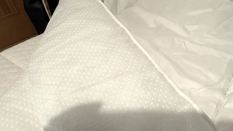 A closeup of the Slumberdown Sleep Soundly Climate Control mattress topper, with its corner folded over showing its rubber grips