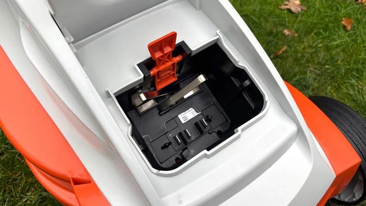 A closeup of the Stihl RMA 235 lawn mower's battery housing