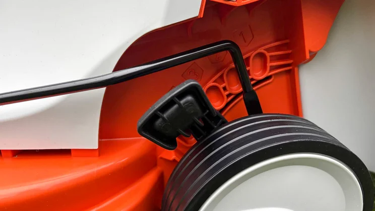 A closeup of the Stihl RMA 235 lawn mower's height adjustment lever