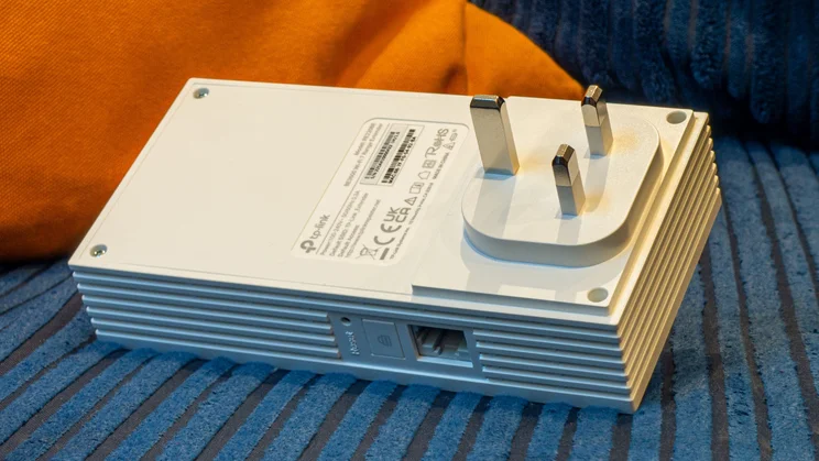 The TP-Link RE220BE wireless extender pictured from the plug side