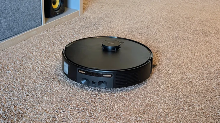 The Tapo RV50 Pro pictured on brown carpet going about its daily clean