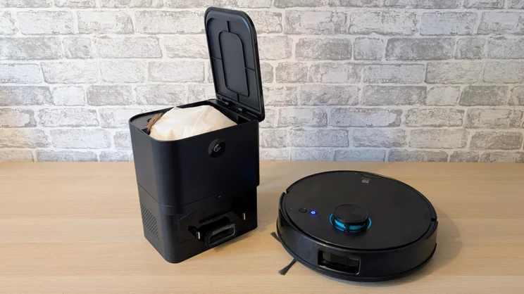 The Ultenic T20 Pro shown next to its dock, open