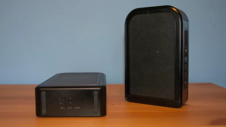 The JBL Bar 1300 MkII's detachable rear speakers, one stood vertically, the other horizontally
