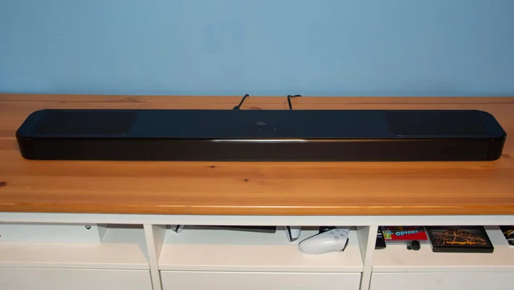 Front view of the JBL Bar 1300 MkII soundbar on a wooden TV stand