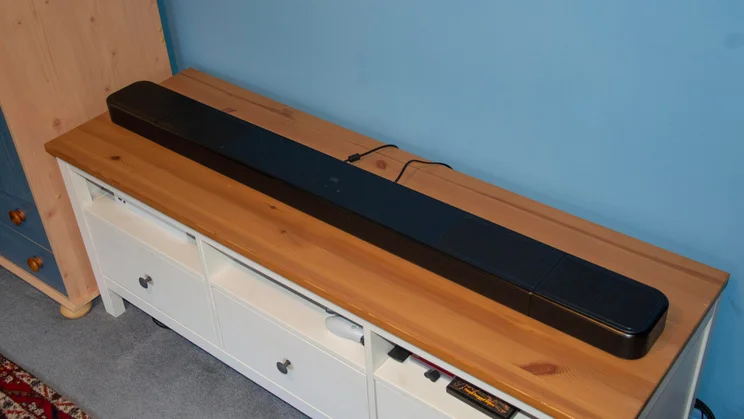 Right view of the JBL Bar 1300 MkII soundbar on a wooden TV stand
